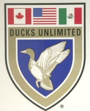 The Ducks Unlimited shield logo, with a flying duck beneath the Canadian, American and Mexican flags